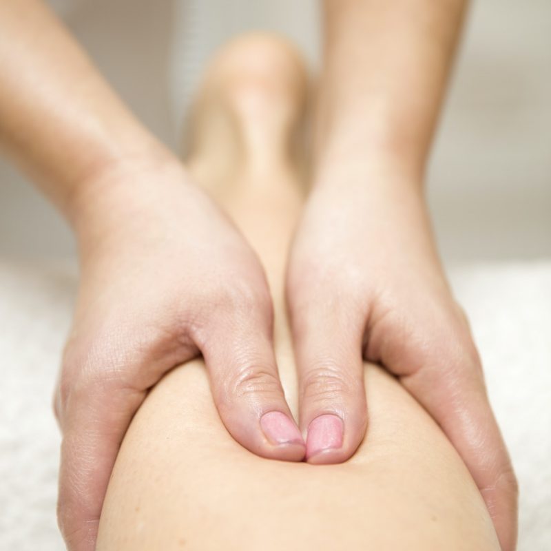 Woman getting leg massage in spa center